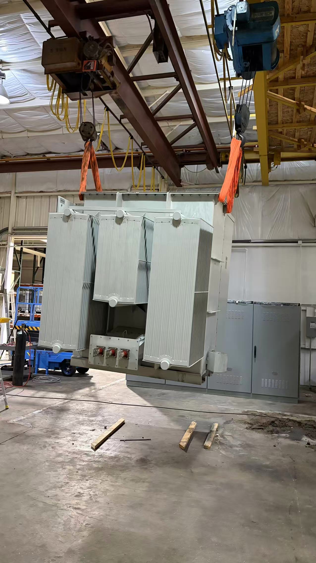 Transformer being lifted into place at a substation